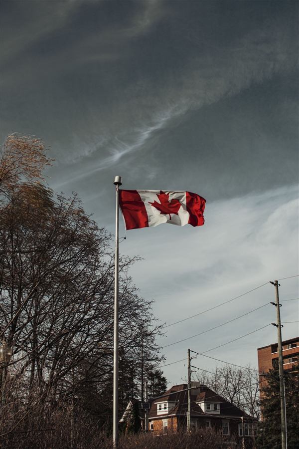 Canadian flag against a stormy sky